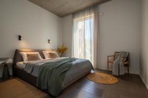 a bedroom with a bed and a large window at 50 meters to the Sea in Juodkrantė