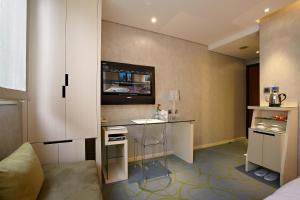 a living room with a tv and a table at Beauty Hotels - Beautique Hotel in Taipei