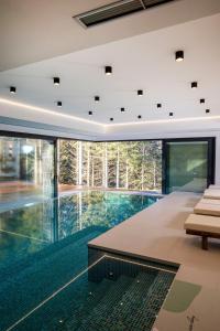 an infinity pool in the middle of a house at Valera Vita Forest House in Hlevci