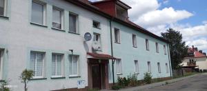a blue and white building on the side of a street at U Magdy apartament dla 4 osób 2 par parking w cenie samodzielne zameldowanie klucze w skrytce kod wysyłany przed przyjazdem in Borne Sulinowo