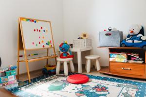 a childs play room with a chalk board and toys at Konrad Guesthouse in Kuressaare +49 photos
