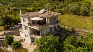 an aerial view of a house with an umbrella at "LaGo Village House" Family & Group Retreat near Meteora in Kalabaka