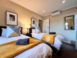 two beds in a hotel room with two beds sidx sidx sidx at Ellefsen 134 Golf Paradise - NEWLY RENOVATED! in Langebaan +27 photos