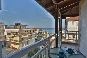 a balcony with a table and a view of the ocean at HOTEL PAVLOS in Paralia Katerinis