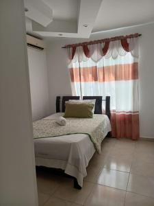 Postel nebo postele na pokoji v ubytování Hotel La Leyenda Vallenata