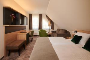a hotel room with a bed and a living room at Parkhotel Neustadt in Neustadt in Sachsen +23 photos