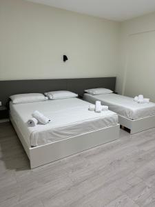 Postel nebo postele na pokoji v ubytování Meraki Hotel