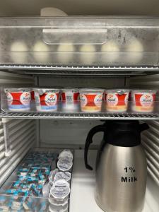a refrigerator with a tea kettle and some milk at Quality Inn Spearfish I-90 in Spearfish