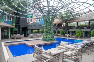 a building with a pool and a glass ceiling at The Blowfish Hotel in Lagos