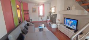 a living room with a couch and a tv at Villa Seven Malo PENTHOUSE in Dunkerque