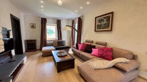 a living room with a couch and a table at Pērles in Durbe