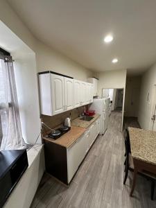 a large kitchen with white cabinets and a table at Hudson Yard 408 in New York