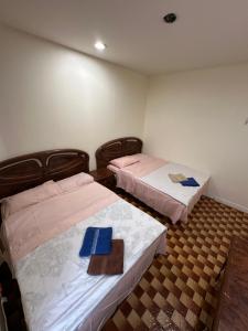 a room with two beds with blue folders on them at Hudson Yard 408 in New York +23 photos