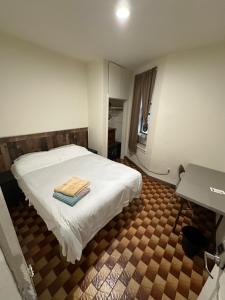 a bedroom with a white bed with towels on it at Hudson Yard 408 in New York