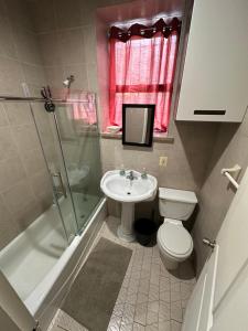 a bathroom with a sink and a toilet and a shower at Hudson Yard 408 in New York