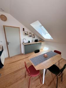 a dining room with a table and red chairs at Rooftop in Jaure