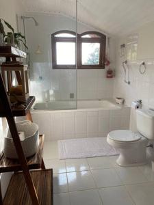 a bathroom with a tub and a toilet and a sink at Lareira forno e fogao a lenha nas montanhas in Camanducaia +34 photos