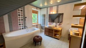 a bathroom with a white tub and a sink at Pērles in Durbe +38 photos