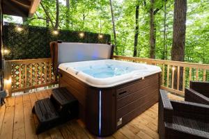 a jacuzzi tub sitting on a deck with trees at Tranquil & Stylish, Wineries, Hiking, 8min to Town in Dahlonega