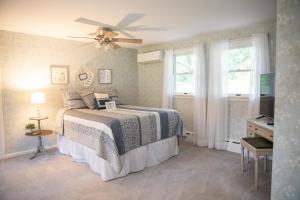 a bedroom with a bed and a ceiling fan at Creekside Farmstead Hot Tub with Brand New Pool and BBQ in Auburn +65 photos