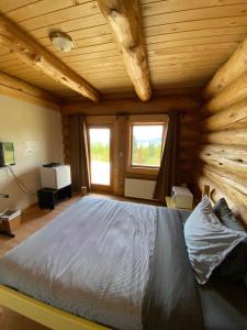 a bedroom with a bed in a log cabin at Williston Lake Resort in Hudson Hope