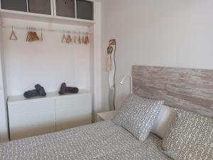 a bedroom with a bed and a wooden headboard at Sky in Noja