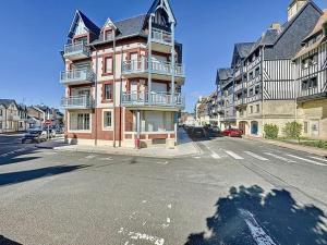 a large building on a city street with an intersection at Le Victorien YourHostHelper in Deauville