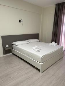 Postel nebo postele na pokoji v ubytování Meraki Hotel