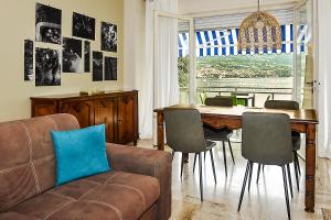 a living room with a couch and a table with chairs at Casa Cristini in Marone