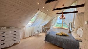 a bedroom with a bed and a dresser and a window at Pērles in Durbe
