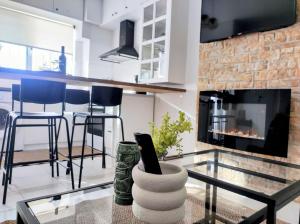 a living room with a glass table and a fireplace at Casa Di Penny 1 in Kyparissia