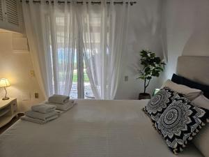 A bed or beds in a room at Corfu Glyfada Beach Apartment 13