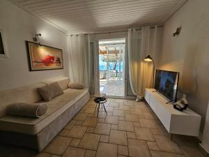 A television and/or entertainment centre at Corfu Glyfada Beach Apartment 13