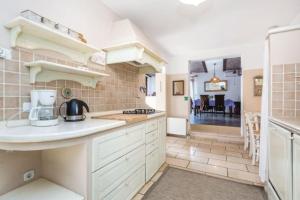 a kitchen with white cabinets and a counter top at Home sweet home- Rab in Barbat na Rabu