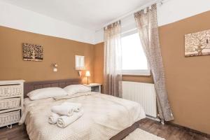 a bedroom with a bed with towels on it at Home sweet home- Rab in Barbat na Rabu