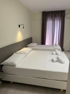 Postel nebo postele na pokoji v ubytování Meraki Hotel