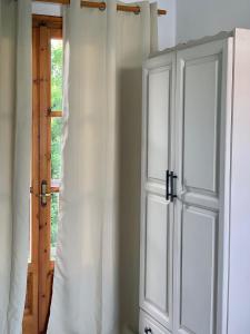 a room with a white door and a window at Skopelos Inn in Stafylos