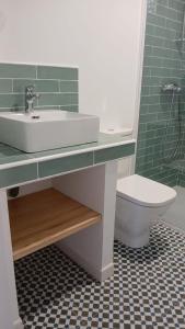 a bathroom with a sink and a toilet at Hostal Terraza Miramar SL in Boiro +64 photos