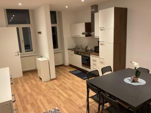 a kitchen and dining room with a table and chairs at Palace Apartment in Vienna