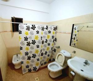 a bathroom with a shower curtain with a toilet and a sink at Garden Villa Dhesara in Ksamil +92 photos