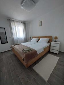 a bedroom with a large bed and a window at Apartments Mišković in Vir +9 photos