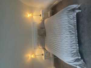 a large bed is in a room with lights at Skellig Port Accomodation - Sea View Rooms Ensuite in Portmagee