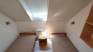 a small room with two beds and a skylight at HauSol Vendégház in Gárdony