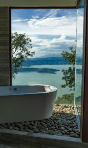 a bath tub sitting in front of a large window at Tres Piedras 