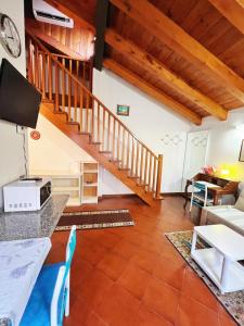 a living room with a staircase and a table at Holiday Treviso Suite Venezia in Treviso