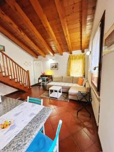a living room with a couch and a table at Holiday Treviso Suite Venezia in Treviso