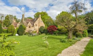 an exterior view of a house with a yard at King Inas Palace in South Petherton