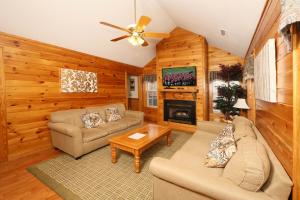 a living room with a couch and a fireplace at Ivy Falls by Eden Crest in Pigeon Forge