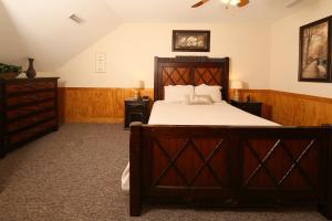 a bedroom with a large wooden bed and two night stands at Ivy Falls by Eden Crest in Pigeon Forge