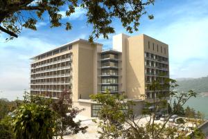 a rendering of a building with a mountain in the background at Fleur de Chine Hotel in Yuchi